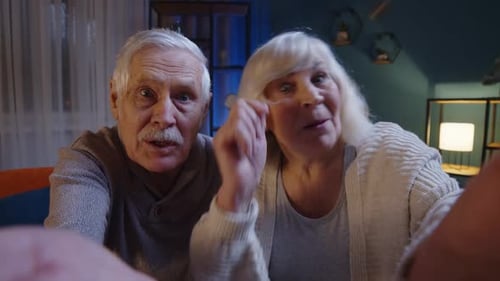 Happy Senior Couple Waving on Video Call