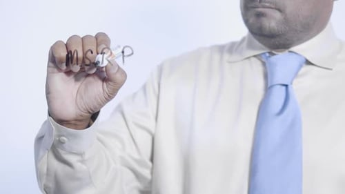 Man Writing MSRP on Clear Surface