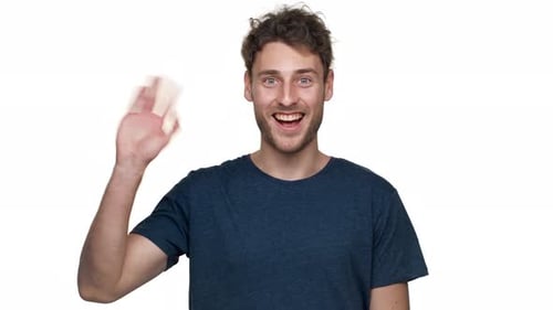 Enthusiastic Young Adult Waving with a Friendly Smile