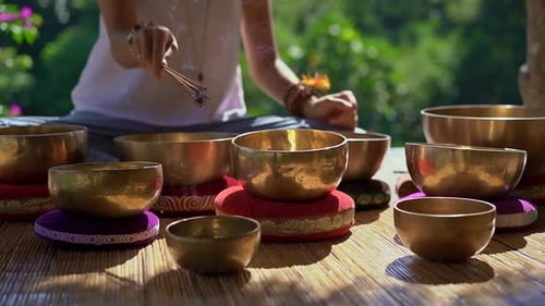 Woman Lights Incense for Singing Bowl Meditation