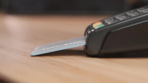 Close Up Man Hand Inserts Credit Card Into the Pos Terminal for Cashless Payment