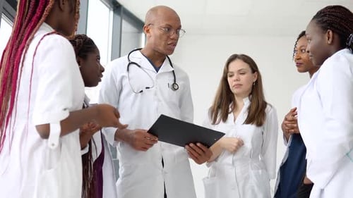 Medical Professionals Discussing Patient Information in Hospital