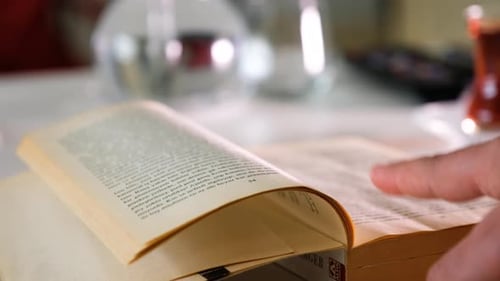 Hand Turning Pages of Book Close Up
