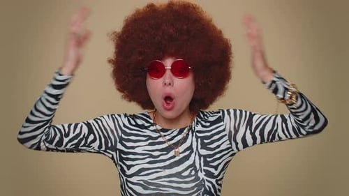 Woman with Afro Wig Expressing Comical Surprise