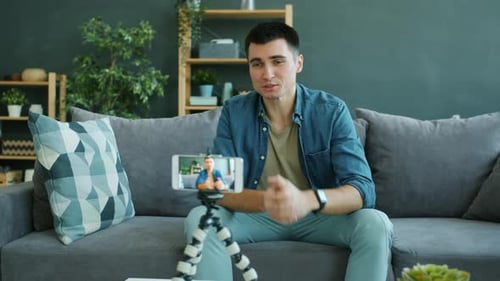 Creative Man Recording Video for Internet Vlog Using Smartphone Camera in Apartment
