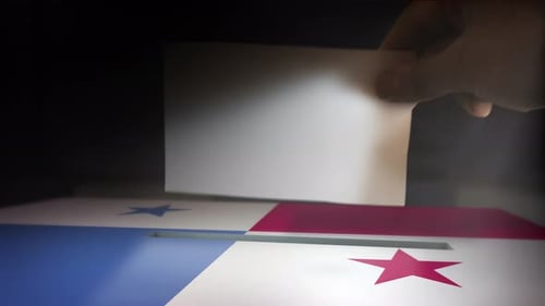 Hand Drops Ballot into Election Box with Panama Flag Design