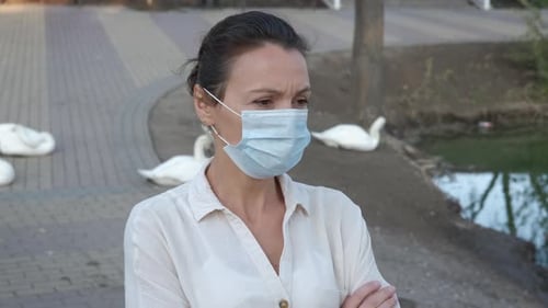 Woman in mask in summer park.