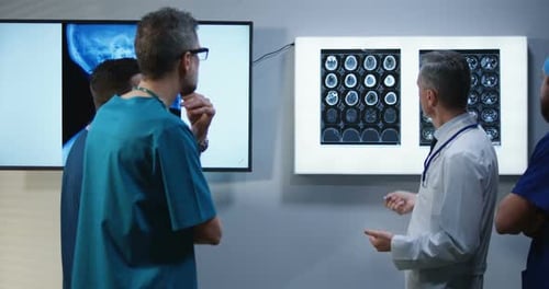 Medical Professionals Reviewing Brain Scans and X-Rays