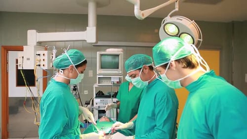 Surgeons Performing an Operation in Hospital Room