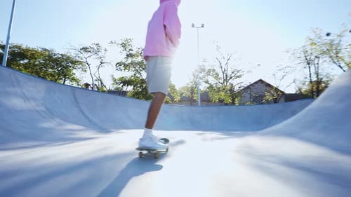 Young Adult Skateboarding in Urban Skate Park