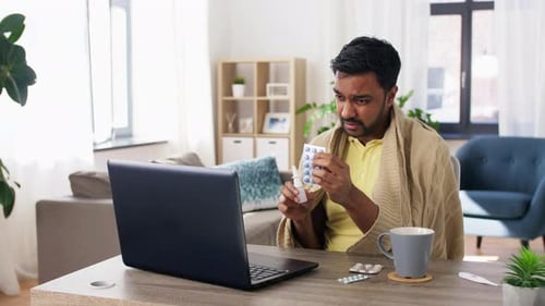 Man Consulting Doctor Via Telehealth While Sick