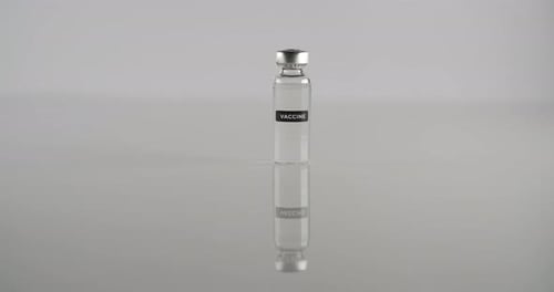 Close Up of Vaccine Vial with Syringe