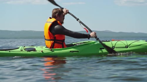 Man Kayaking on Lake