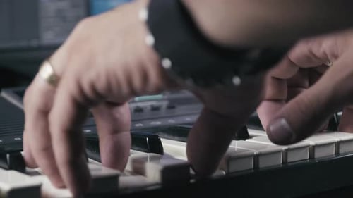 Musician's hands while plays keyboards, close up 4K.