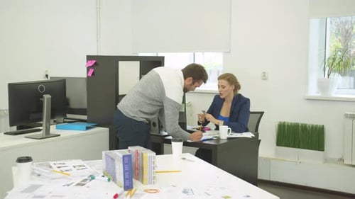 Collaborative Team Discussing Project in Modern Office