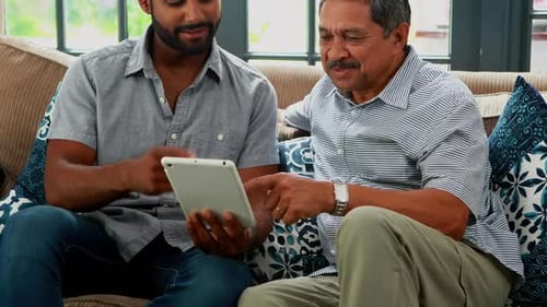Man and Senior Man Using Tablet at Home