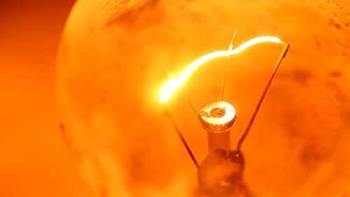 Close Up of Lightbulb Filament Glowing Orange