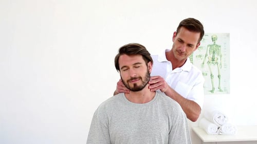 Man Receiving Neck Massage From Medical Professional