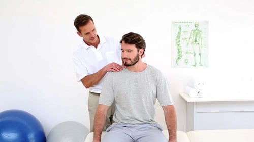 Chiropractor Adjusting Patient's Neck and Shoulders