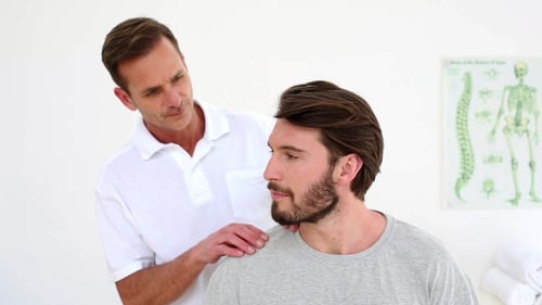 Physical Therapist Massaging Man's Neck and Shoulders