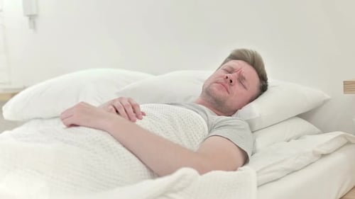 Man Wakes Up Confused in a White Bed