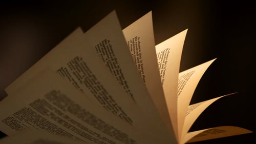 Seamlessly Flipping Book Pages with Warm, Dramatic Lighting