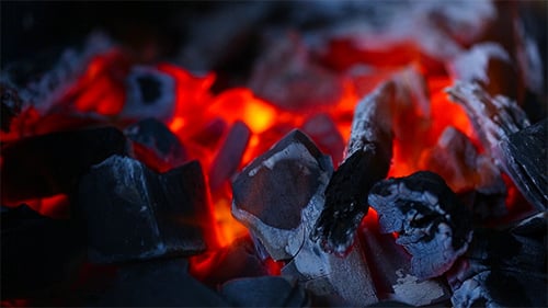 Glowing Embers Amongst Black Charcoal Close Up
