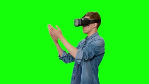 Young Adult Using VR Headset on Green Screen