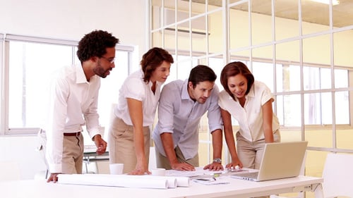 Architects Collaborating on Project at Office Table