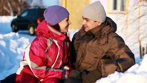Happy Couple Relaxing Together in the Snow