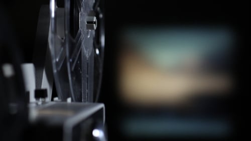 Vintage Film Projector Spinning Reels in the Dark