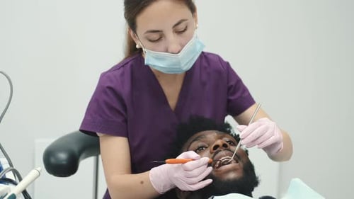 Professional Dentist Working with Gloves During Examination