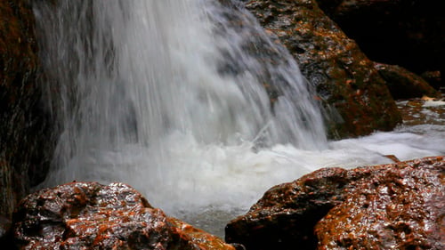 Rushing Waterfall Cascades Over Natural Rocks