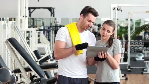 Young People Using Digital Tablet at Gym