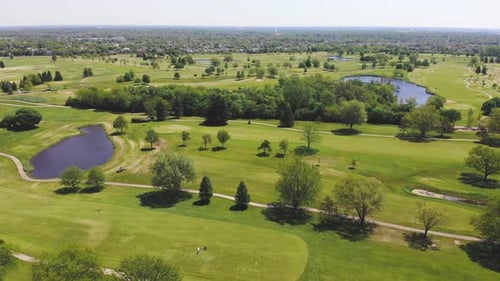 Aerial View From the Top n of the Golf Course. People and Cars on a Golf Course From a Height.