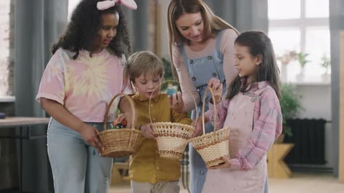 Woman and Children Looking at Easter Eggs