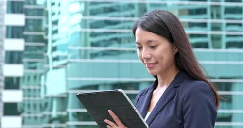 Woman Using Tablet Device in Urban Setting