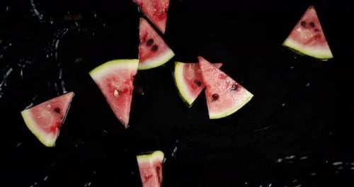 Watermelon Slices with Seeds on a Black Background