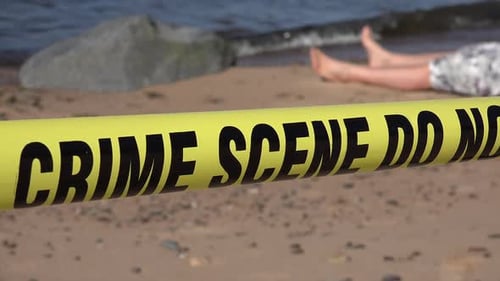 Crime Scene with Crime Tape on Beach