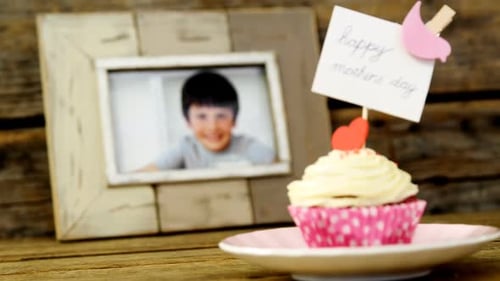 Close-up of delicious cupcake with happy mothers day label