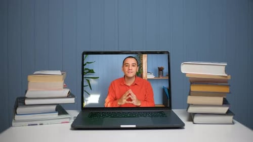 Online Video Conference on Laptop with Books