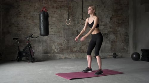 Young beautiful girl doing squats in the gym. close up of legs, 4k.
