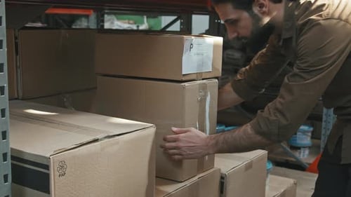 Man Moving Boxes in Warehouse