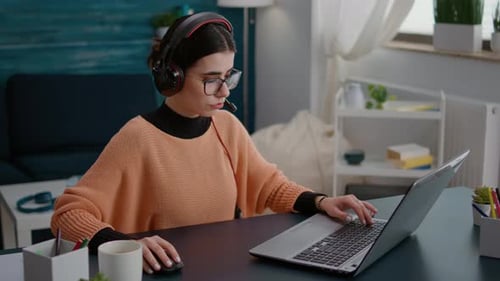Woman Working at Laptop in Home Office