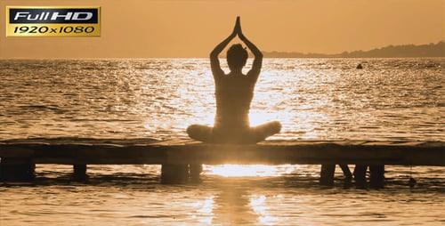 Woman Silhouetted Doing Yoga on Ocean Pier at Sunrise