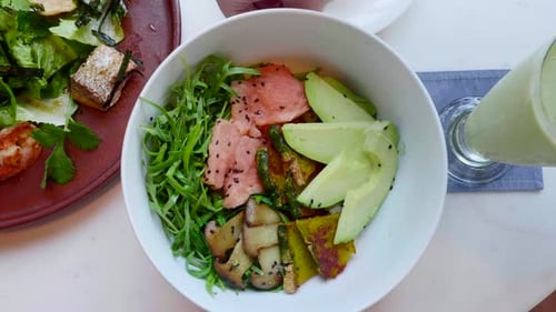 Salmon Salad with Avocado Zucchini Top View Hands Rotating