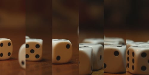 Rolling Dice on Wood Surface in Close Up