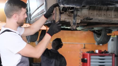 American Mechanic Working in a Car Service Center