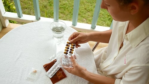 Woman Taking Pills and Tablets
