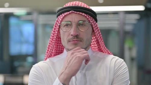 Man in Head Covering Gets an Idea